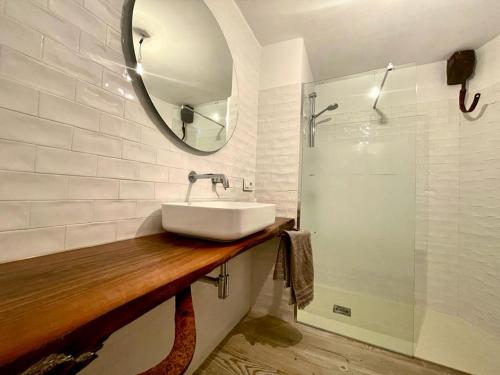 a bathroom with a sink and a mirror and a shower at Cortijo la Noria II in Puebla de Don Fadrique