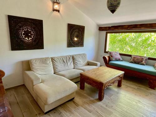 a living room with a couch and a table at Cortijo la Noria II in Puebla de Don Fadrique