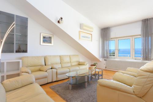 a living room with a couch and a table at Apartments by the sea Duce, Omis - 946 in Duće