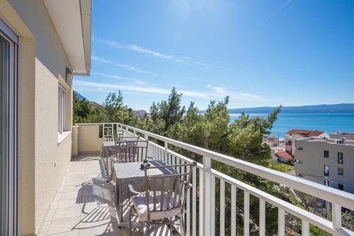 a balcony with chairs and a view of the water at Apartments by the sea Duce, Omis - 946 in Duće