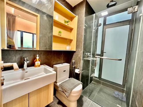 a bathroom with a toilet and a sink and a shower at The Luxe Colony KLCC BY Infinitum in Kuala Lumpur