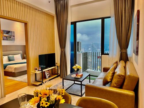 a living room with a couch and a large window at The Luxe Colony KLCC BY Infinitum in Kuala Lumpur