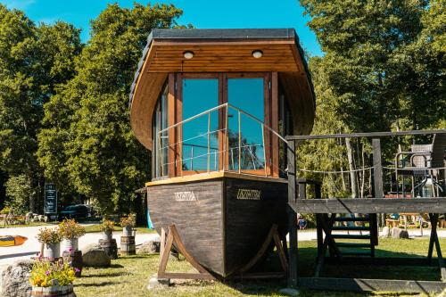 a small tree house on a playground at Viesu nams Melnsils in Melnsils