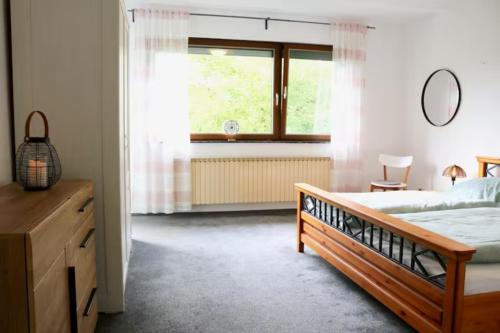 a bedroom with a bed and a window at Ferienwohnung Bliestalglück in Oberthal