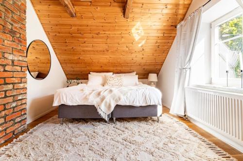 1 dormitorio con cama y pared de ladrillo en Fully Equipped Apartment Close to Malmö & Copenhagen en Vellinge