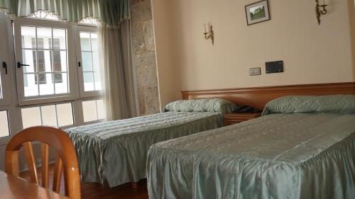 Ein Bett oder Betten in einem Zimmer der Unterkunft Hotel Larry