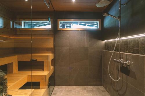 a bathroom with a shower and a glass shower stall at Luxury Villa Lapland in Rovaniemi