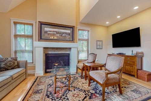 a living room with a fireplace and a tv at A1 at Castle Hill in Cavendish