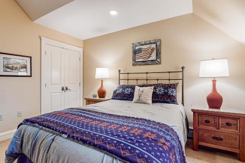 a bedroom with a large bed and two lamps at A1 at Castle Hill in Cavendish