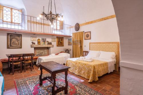 a bedroom with two beds and a dining room at Palazzo Danesi in Montepulciano