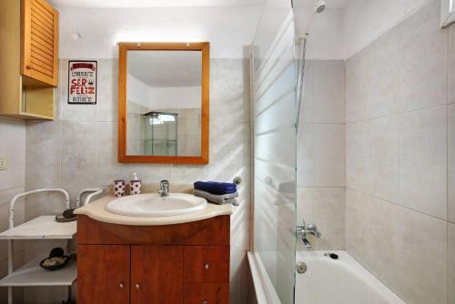 a bathroom with a sink and a shower and a mirror at El Cazador 1 in Granadilla de Abona