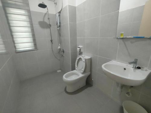 a white bathroom with a toilet and a sink at Sierra Hill Homestay 