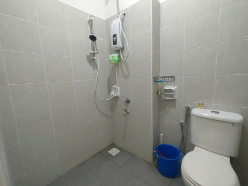 a bathroom with a shower with a toilet in it at Sierra Hill Homestay 