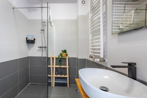 a bathroom with a white tub and a shower at Apart Invest Widok 800 M3 in Szklarska Poręba