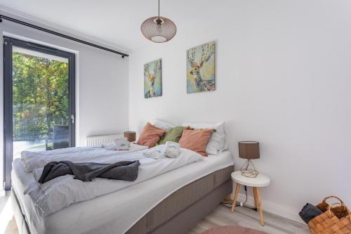 a bedroom with a large bed and a window at Apart Invest Widok 800 M3 in Szklarska Poręba