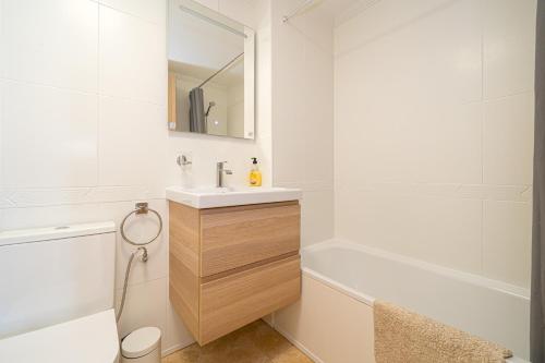 a white bathroom with a sink and a bath tub at Villamartin in Villamartin