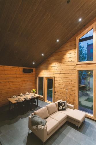 a living room with a couch and a table at Luxury Villa Lapland in Rovaniemi