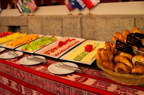 a table topped with different types of food and bread at Santuario Machupicchu in Machu Picchu