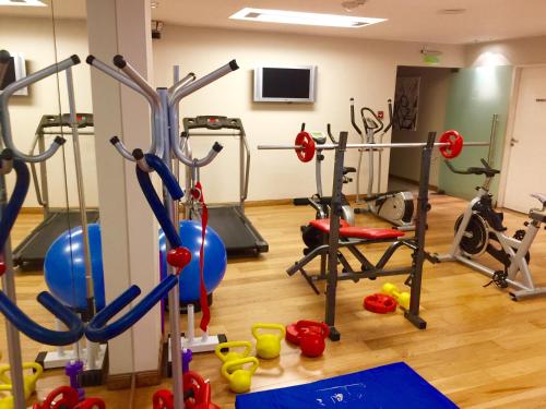 a gym with treadmills and exercise equipment in it at Purobaires Hotel Boutique in Buenos Aires