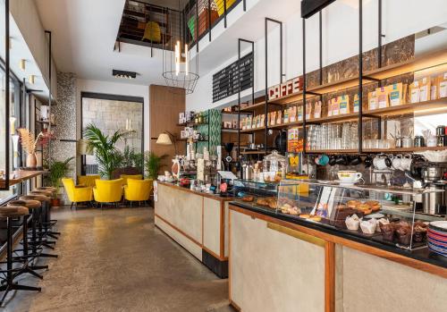 a restaurant with a counter with yellow chairs at BSJ15-Borgo San Jacopo Room in Florence