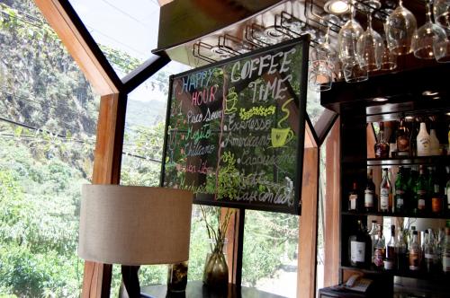 a restaurant with a chalkboard sign in a bar at Santuario Machupicchu in Machu Picchu