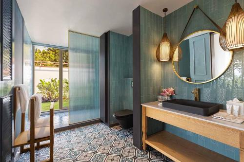 a bathroom with a sink and a mirror at Storii By ITC Hotels Moira Riviera in Moira