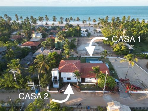 an aerial view of casa and the beach at Casas Oceanicas in Icaraí