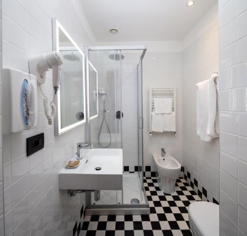 a white bathroom with a sink and a shower at Best Western Hotel Crimea in Turin