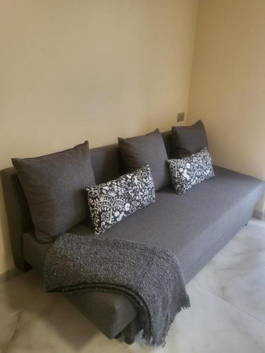 a gray couch with pillows on it in a room at casa Hanna2 in Intra