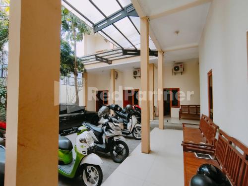 a group of motorcycles parked in a building at Calida Hotel Mitra RedDoorz near Alun Alun Wonosari in Wonosari