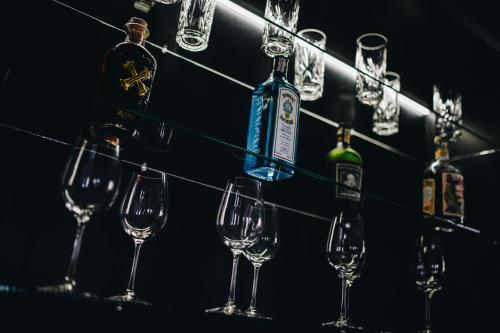 a group of wine glasses and bottles on a bar at Kounický dvůr in Dolní Kounice