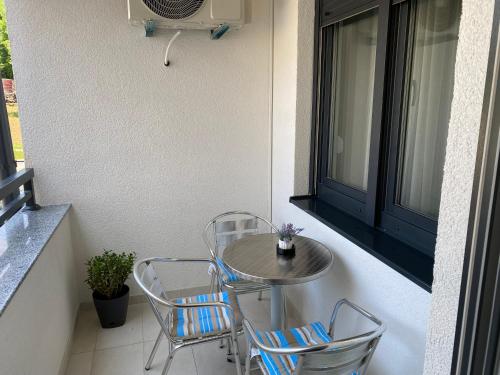 a small table and chairs on a balcony at Zeus in Hiseti