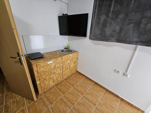 a corner of a room with a television on a wall at Budget Apartment LeLo Centar 5 in Osijek