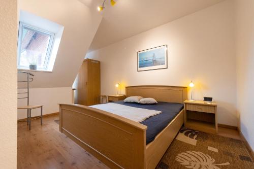 a bedroom with a bed and a window at ST4-09 - Ferienwohnung in Dorum-Neufeld