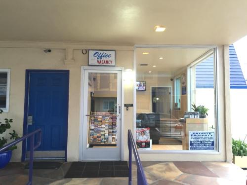 a store entrance with a blue door and a window at Surf Motel in San Francisco