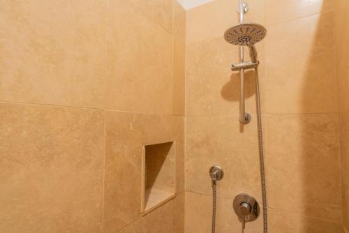 a shower with a shower head in a bathroom at Palazzo Danesi in Montepulciano
