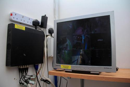 a computer monitor sitting on a desk with headphones at Kindo Kicha Farmhouse in Moshi