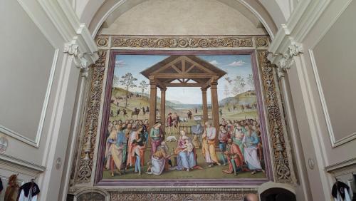 a painting of a group of people on a wall at Il Loft di Pieve in Città della Pieve