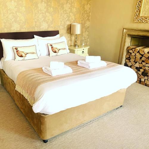 a large bed with two towels on top of it at The Red Lion in Lacock