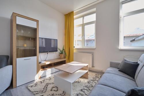 a living room with a couch and a tv at Central Apartments in Martin