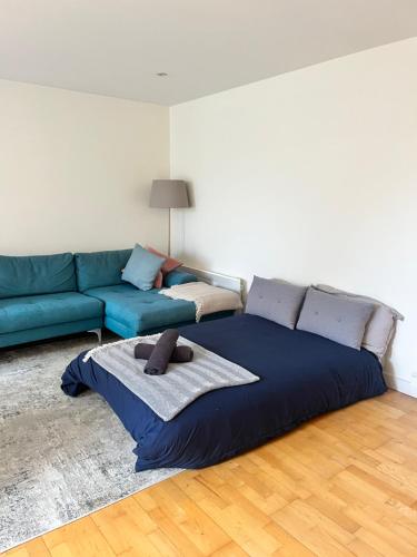 ein Wohnzimmer mit einem Bett und einem Sofa in der Unterkunft Spacious Mews Apartment, Clapham in London