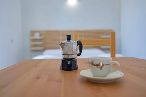 a coffee maker and a cup on a wooden table at Agriturismo Le Tagliate in Uggiano la Chiesa