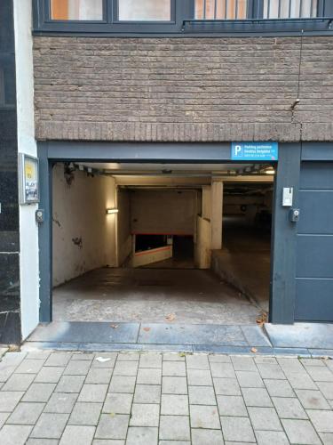 an empty parking garage with a blue door at The Banker Antwerpen - Free Parking in Antwerp