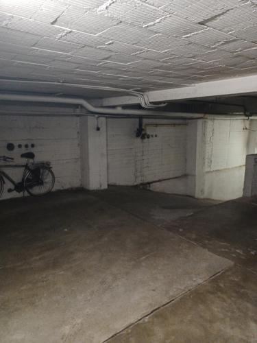 an empty parking garage with a bike parked in it at The Banker Antwerpen - Free Parking in Antwerp