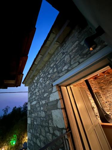 a door to a stone house at night at EJ Boutique Suites in Milina