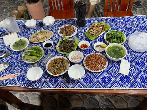a blue and white table topped with plates of food at Mường Lò Corner in Yên Bái