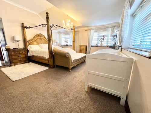 a bedroom with a bed and a dresser and windows at Reads Lodge in Waterlooville