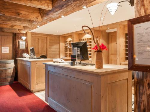 a kitchen with a counter with a computer on it at Résidence & Spa Les Sources de Marie - Arc 1950 Le Village in Arc 1950