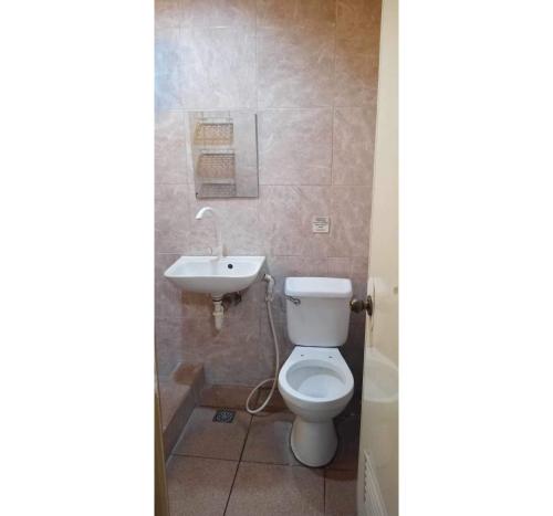 a bathroom with a toilet and a sink at OYO 1026 Evita Hotel Bacoor in Cavite