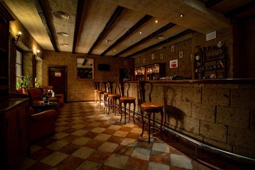 a bar with a row of stools in a room at House of Dracula Hotel in Poiana Brasov